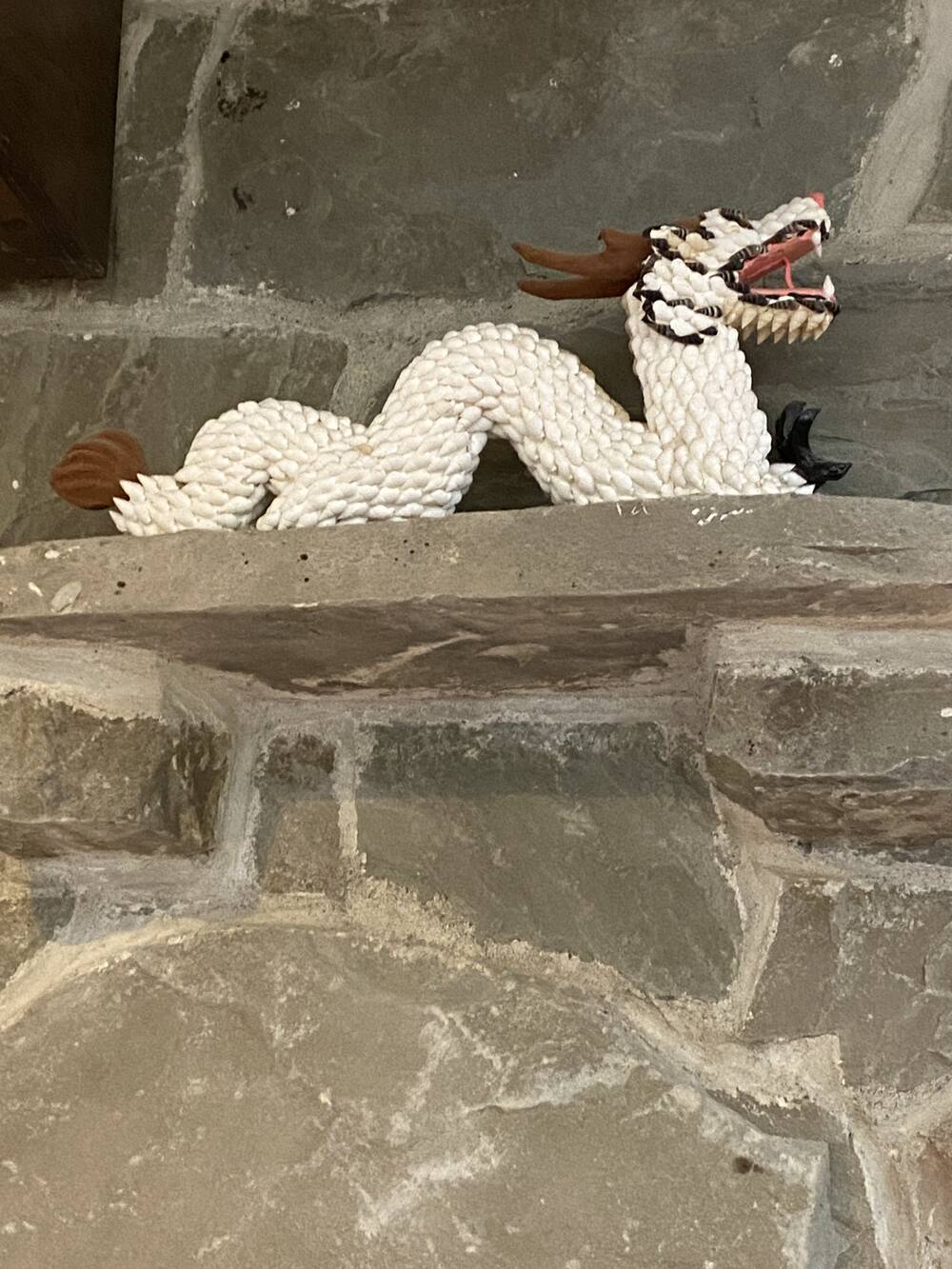 white dragon statue on shelf